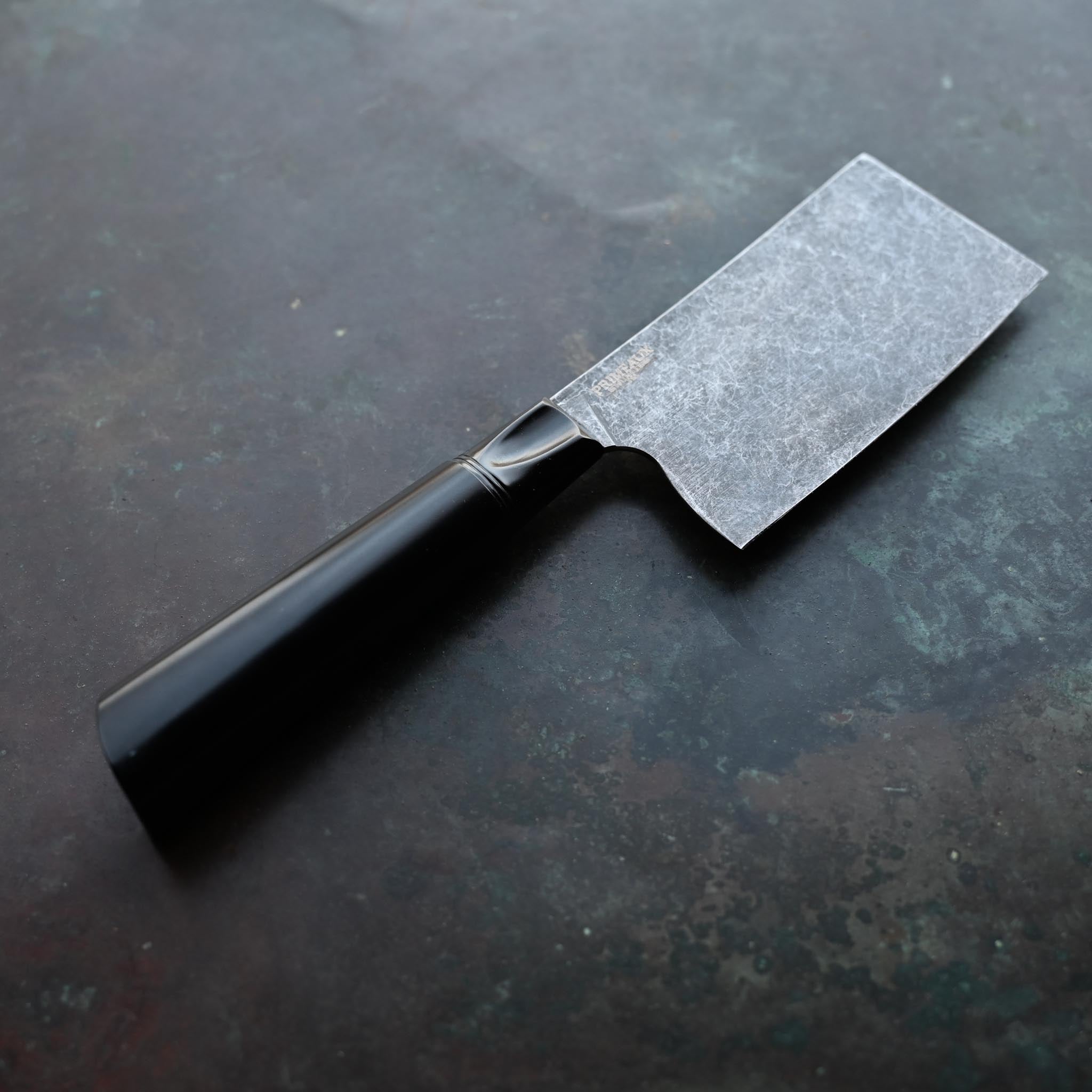 STONEWASH MINI CLEAVER OBSIDIAN KITCHEN KNIFE BLACK BOLSTER AND BLACK HANDLE ON CONCRETE BACKGROUND